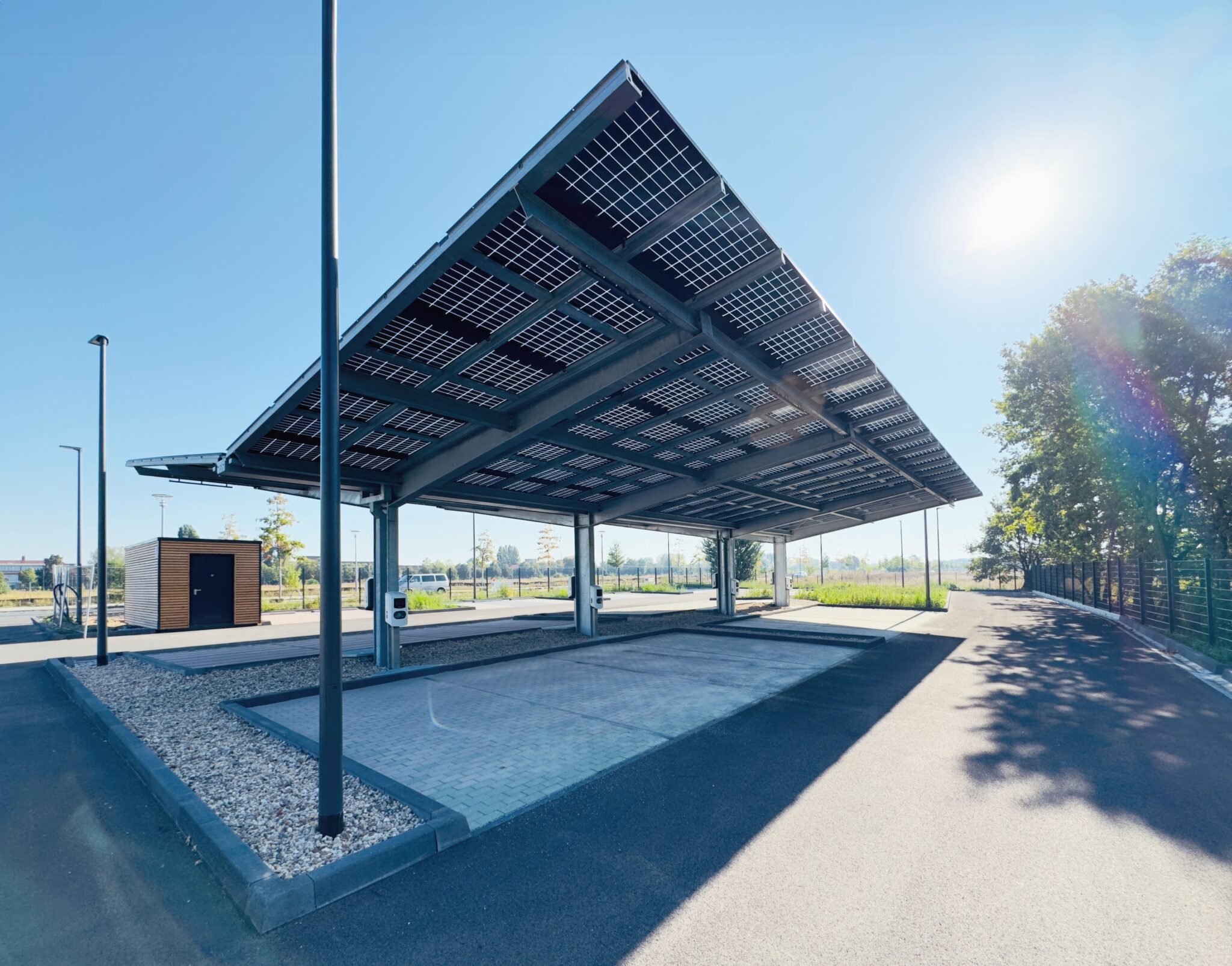 Solar carport structure generating energy and providing shaded parking.
