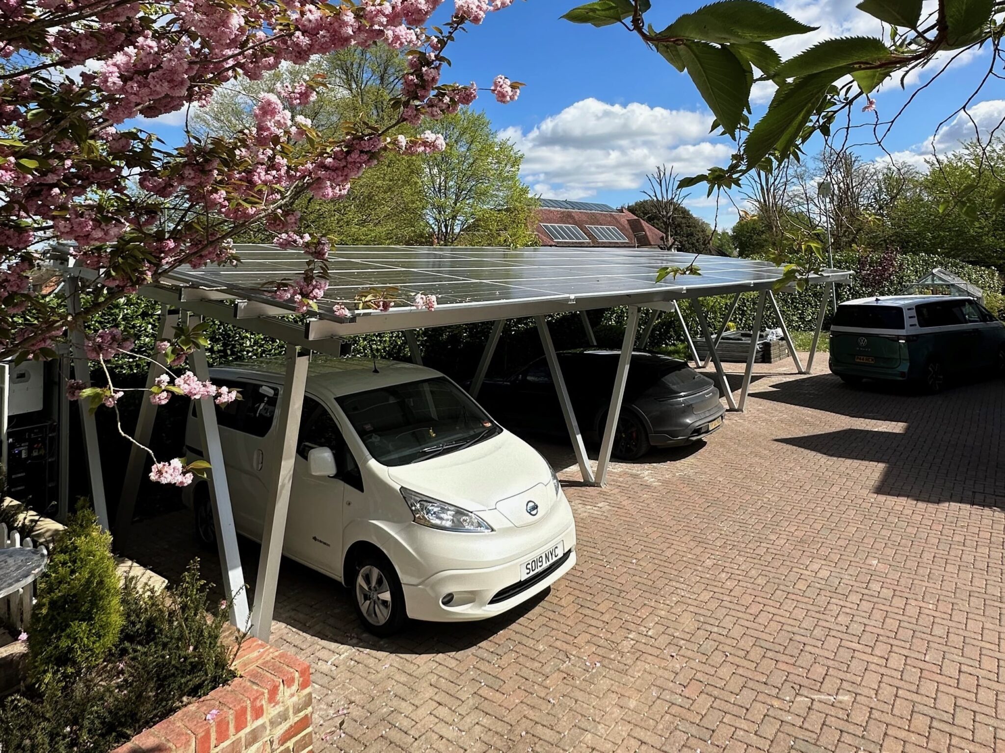 Modern solar carport powering a commercial site with parked vehicles below.